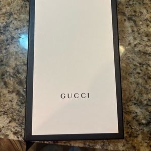 Woman’s white Gucci slides